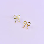 gold bow stud acrylic earrings